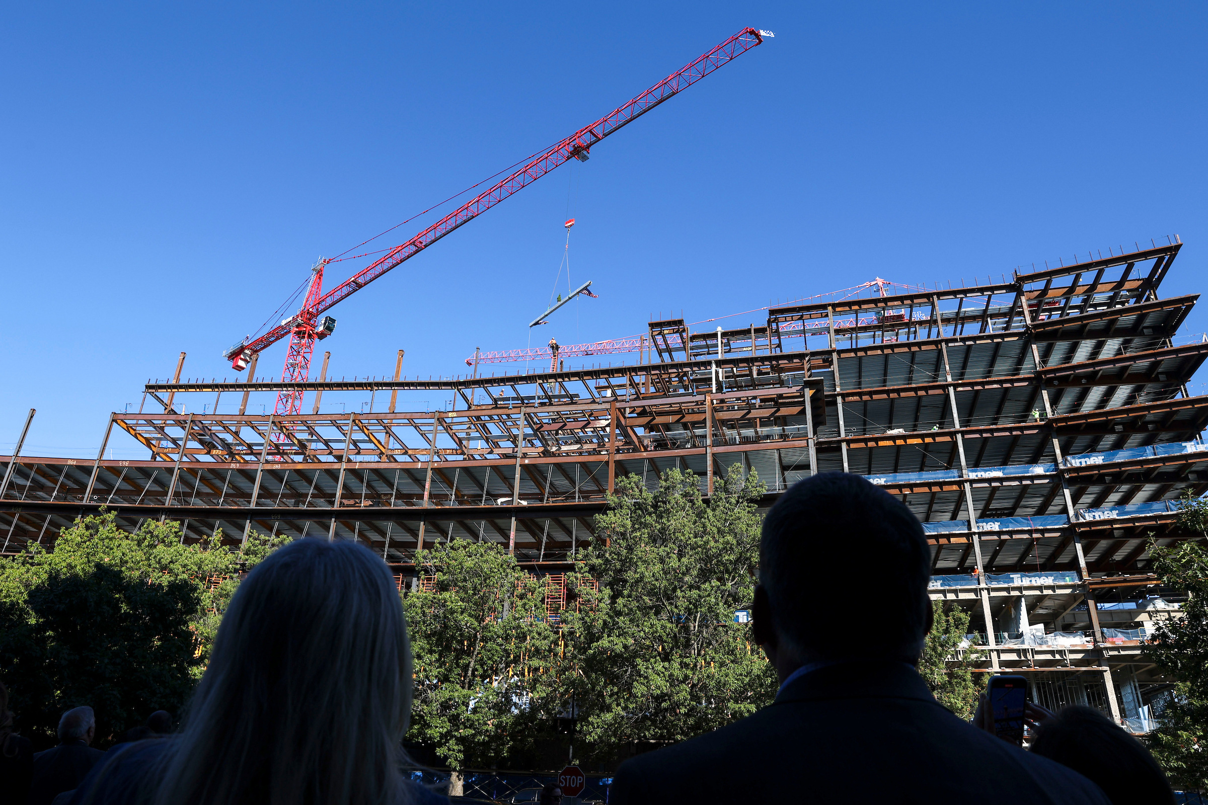 Topping out ceremony of the Rankin Health Education Building at UK where a beam is lifted into place by a crane.
