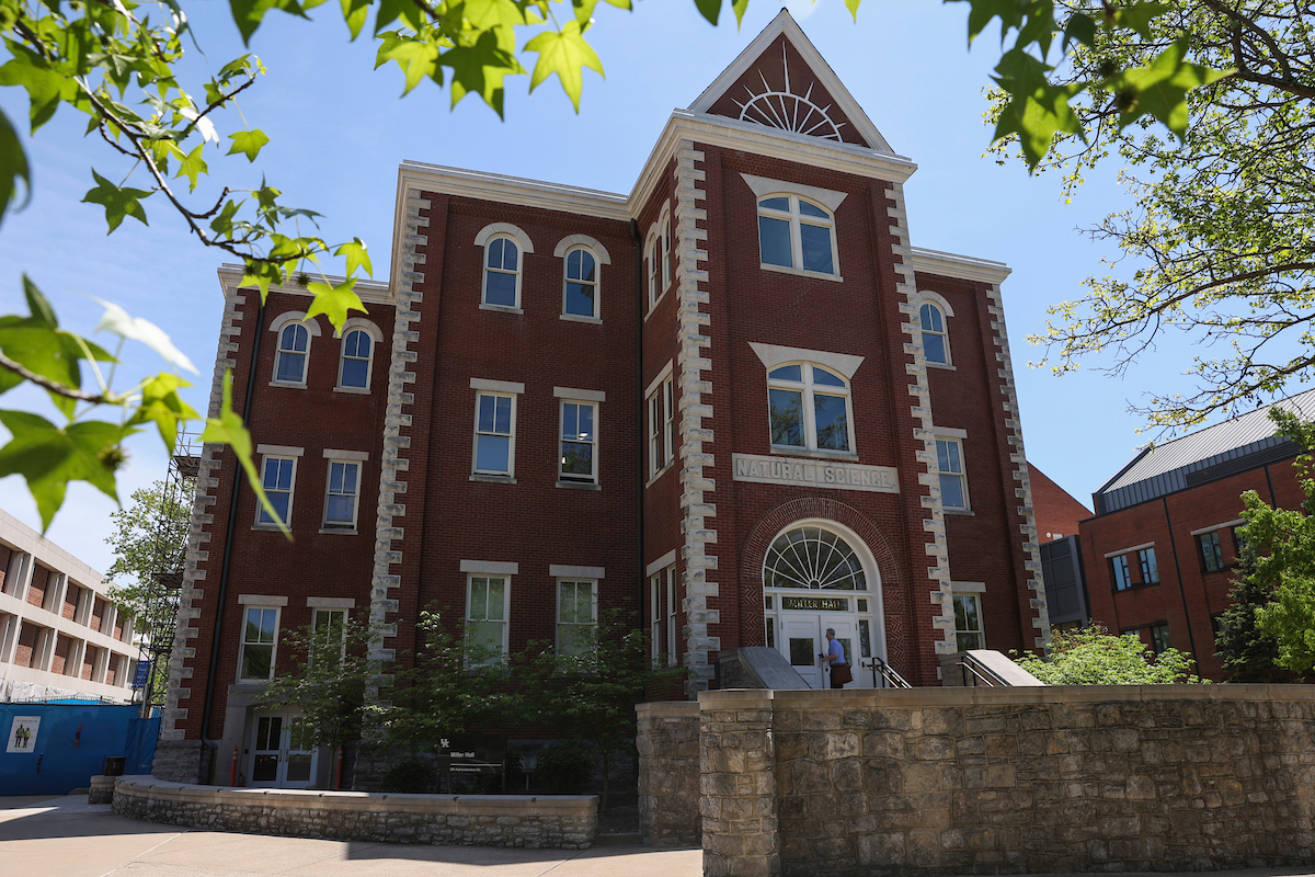 Miller Hall at the University of Kentucky from the front with a man walking up the steps to the door.