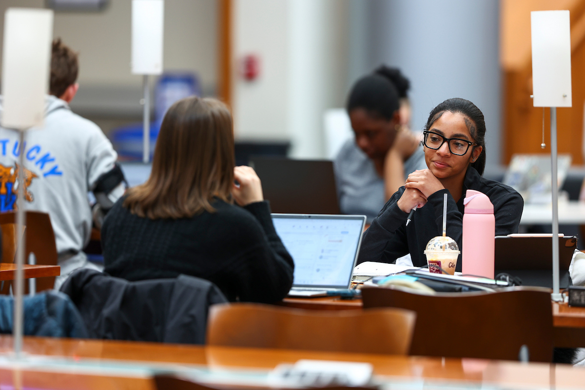Students studying at a table in the Gatton College of Business and Economics.