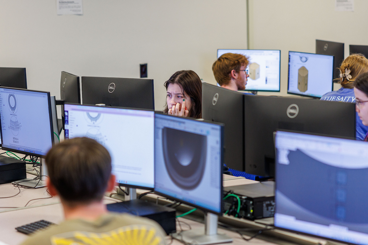 a classroom of students working in a computer lab