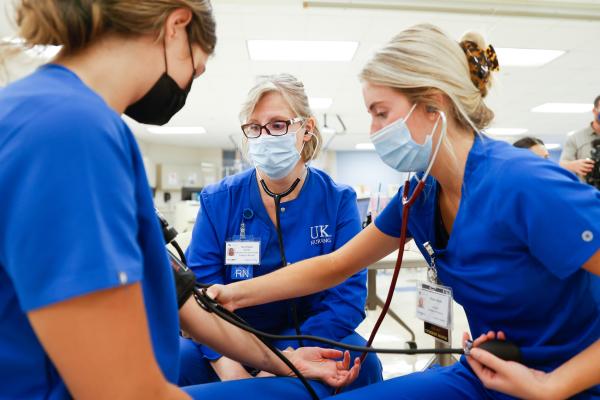 Nursing students take blood pressure measurements