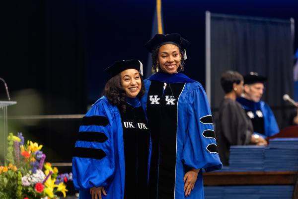danelle stevens-watkins standing with one of her doctoral students at commencement