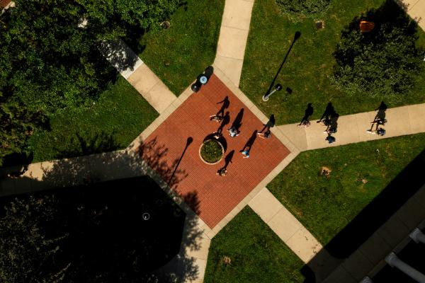 aerial view of a red brick courtyard with students walking 