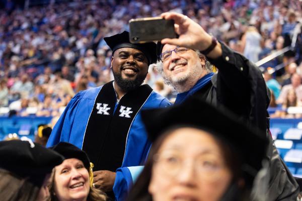 Two people pose for a selfie at UK Commencement.
