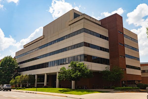 The College of Nursing at UK, a limestone facade building with five stories seen from outside.