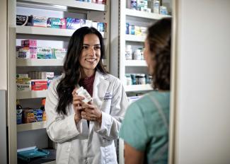 Pharmacy student gives a prescription