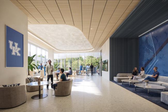 The student commons of the Health Education Building with lounge-style seating and tall, floor-to-ceiling windows.