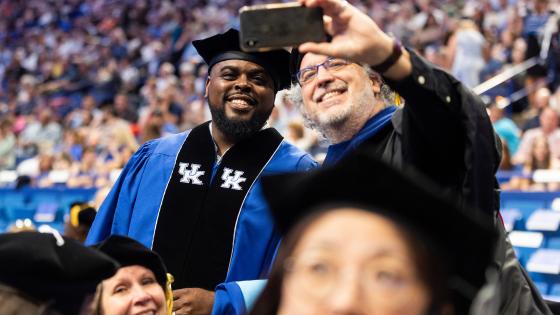 Two people pose for a selfie at UK Commencement.