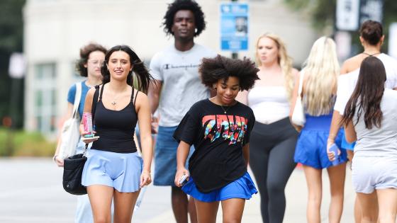 Students at UK walking along the sidewalk as they move into their residence halls.