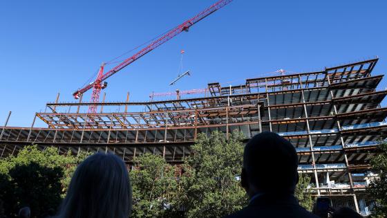 Topping out ceremony of the Rankin Health Education Building at UK where a beam is lifted into place by a crane.