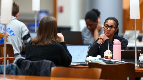 Students studying at a table in the Gatton College of Business and Economics.