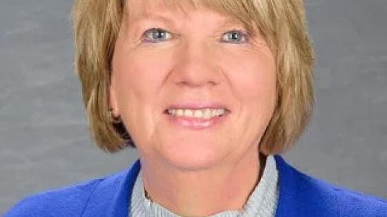 Headshot of Kim Anderson in a blue blazer.