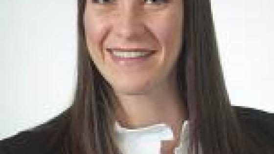 Headshot of Enif Dominguez-Fernandez in a white shirt and black blazer.