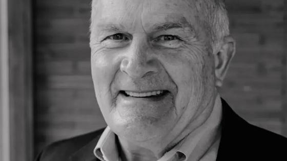 Black and white headshot of Mark O'Bryan in a jacket and collared shirt.