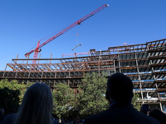 Topping out ceremony of the Rankin Health Education Building at UK where a beam is lifted into place by a crane.