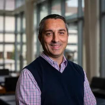Headshot of Bjorn Bauer in a black sweater vest.