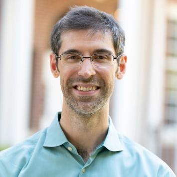 Headshot of Joe Hammer in a light blue collared shirt.