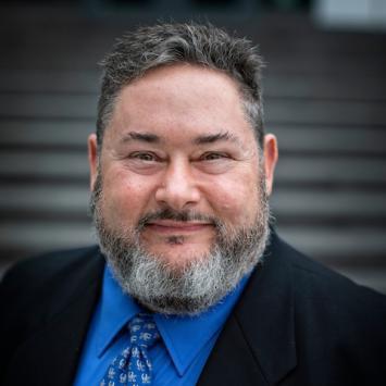 Headshot of Michael Murray in a suit and tie.