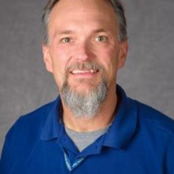 Headshot of Gregg Rentfrow in a blue collared shirt.