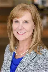 Gwen Moreland, D.N.P., posed for a portrait wearing a blue blouse and heathered gray blazer. 