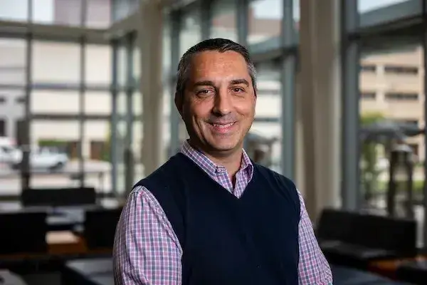 Headshot of Bjorn Bauer in a black sweater vest.