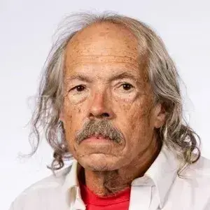 Headshot of JS Butler in a white collared shirt.