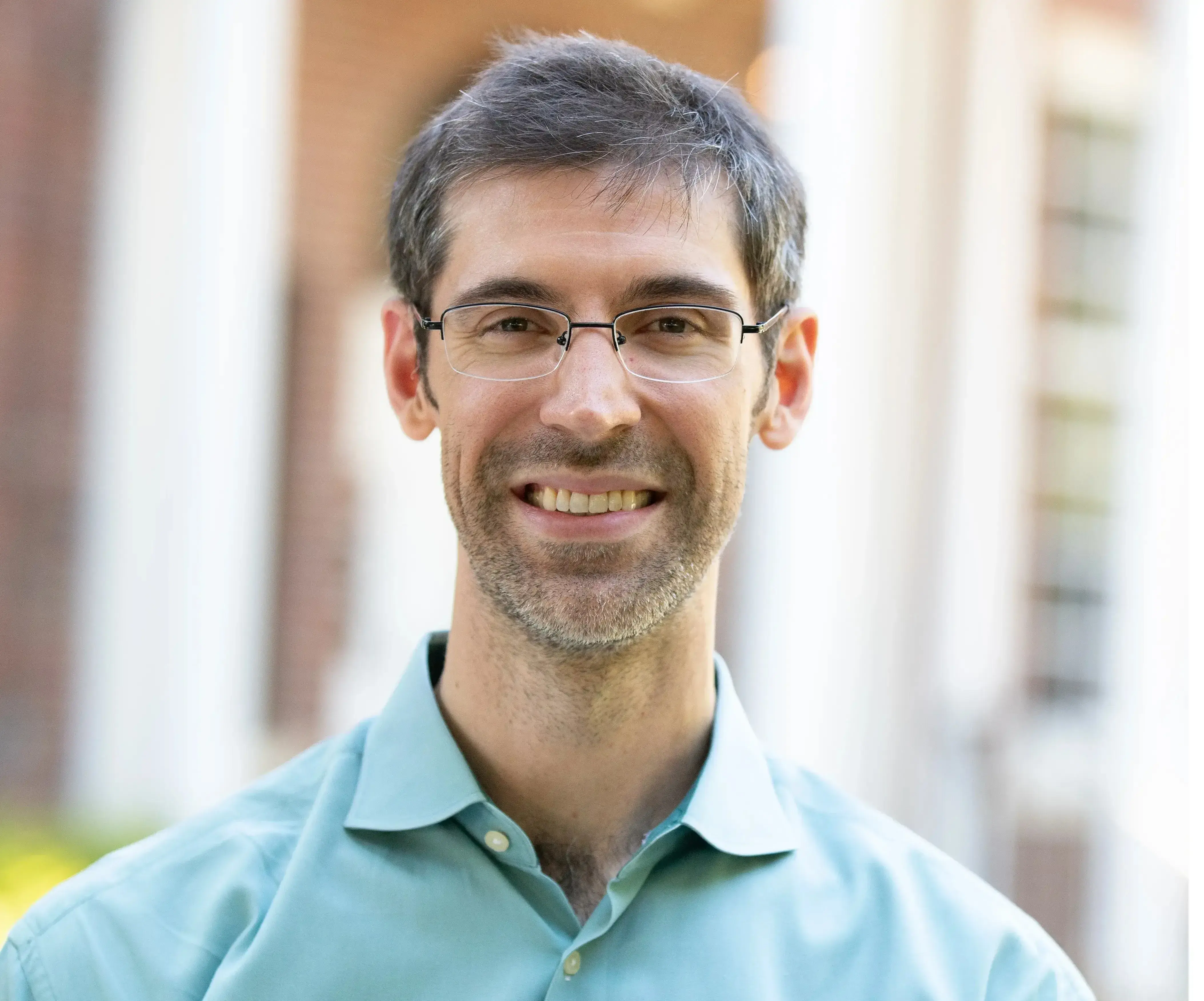 Headshot of Joe Hammer in a light blue collared shirt.