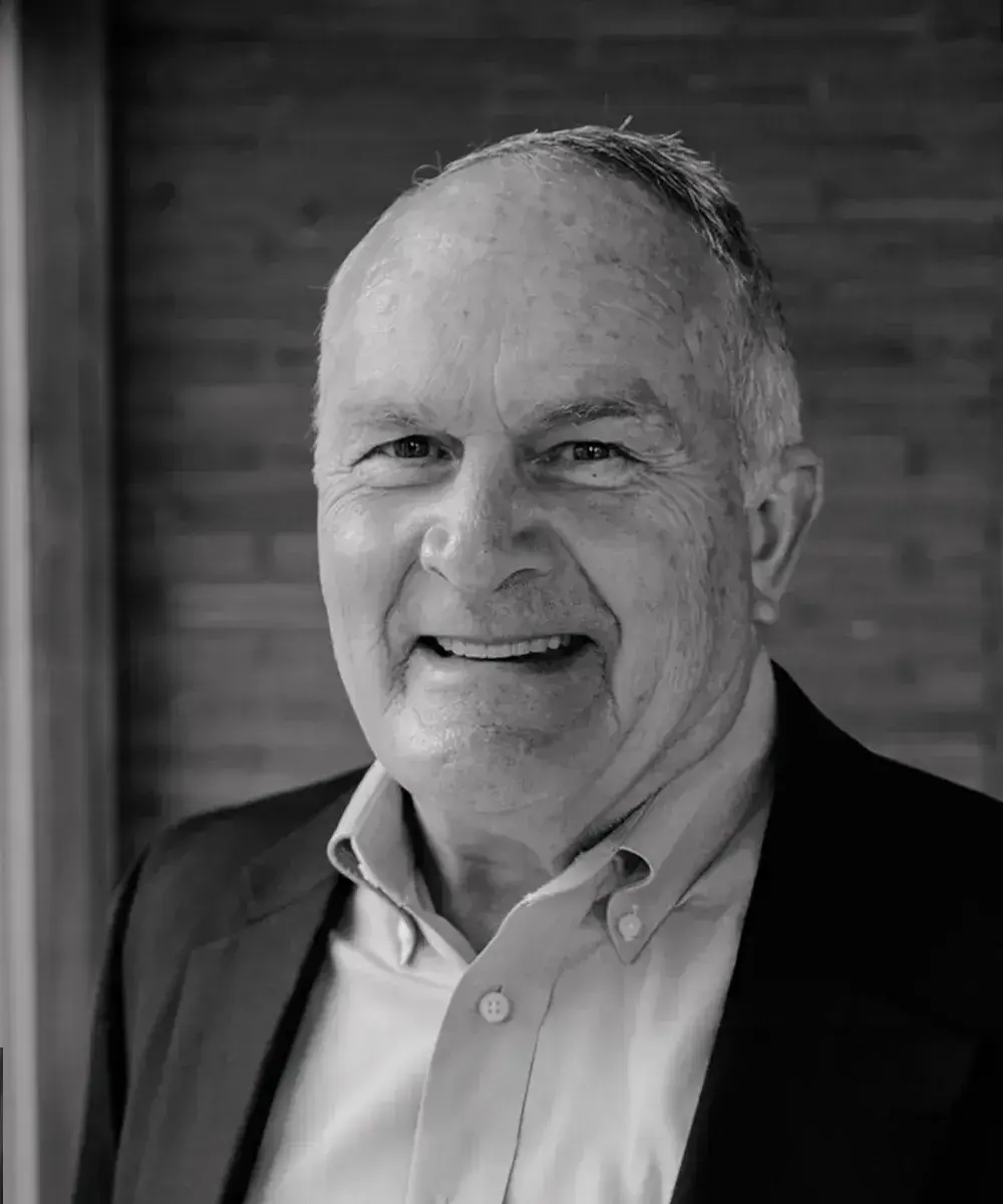 Black and white headshot of Mark O'Bryan in a jacket and collared shirt.